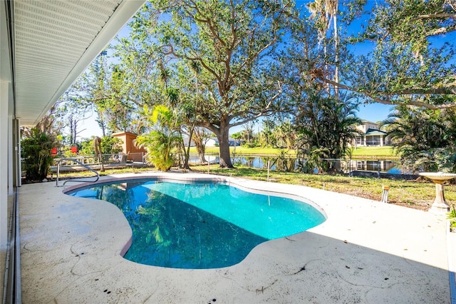 view of pool with a patio area and a water view