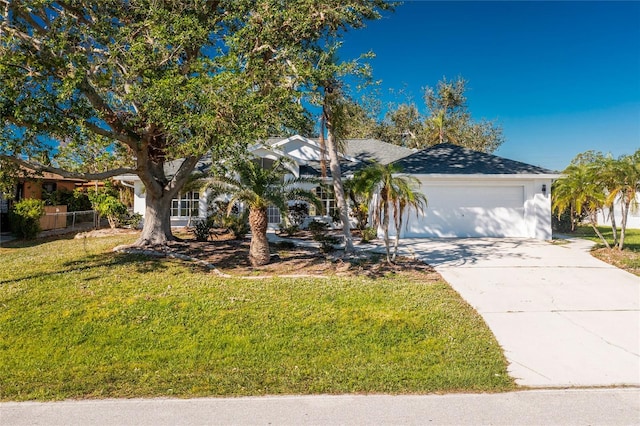 view of front facade with a front yard and a garage