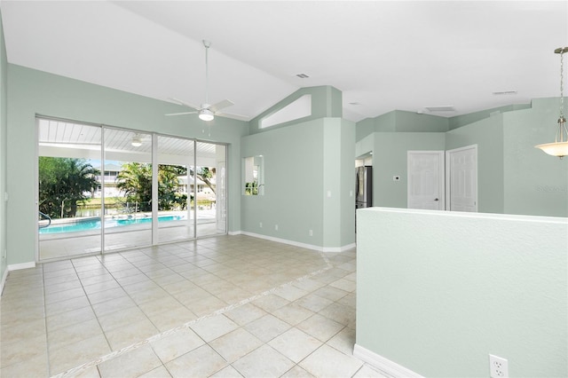 tiled spare room featuring ceiling fan and vaulted ceiling