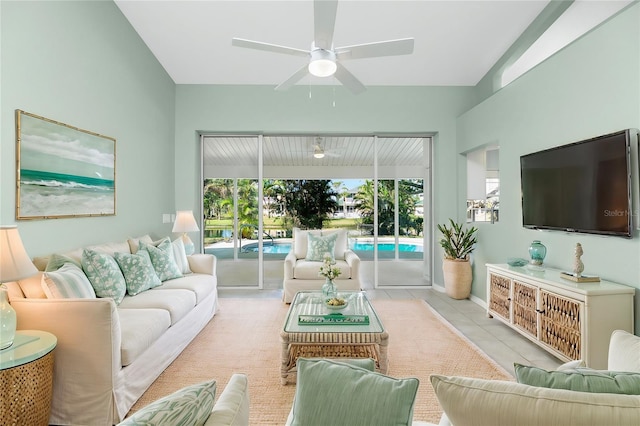 tiled living room with ceiling fan and vaulted ceiling