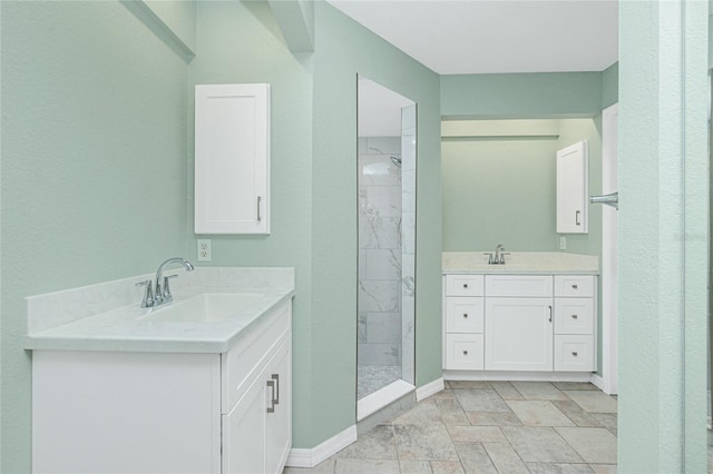 bathroom featuring tiled shower and vanity