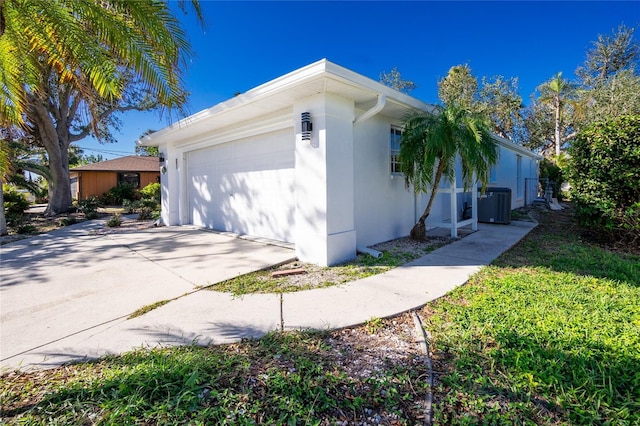 217 Rotonda Cir, Rotonda West, FL 33947 - view of property exterior with a garage, driveway, and stucco siding