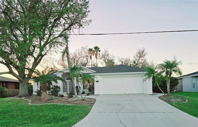 217 Rotonda Cir, Rotonda West, FL 33947 - single story home featuring driveway, an attached garage, a front yard, and stucco siding