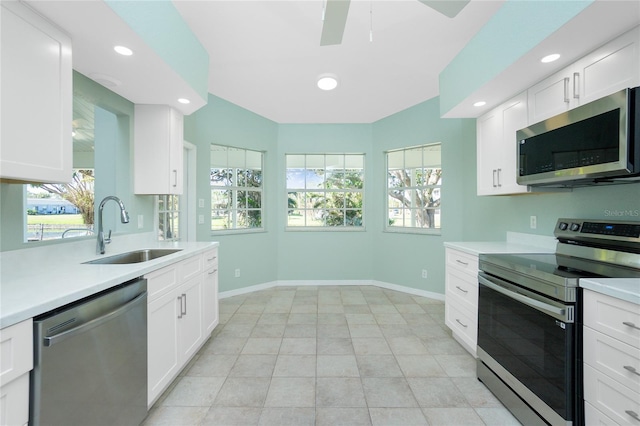 217 Rotonda Cir, Rotonda West, FL 33947 - kitchen with appliances with stainless steel finishes, light countertops, recessed lighting, and white cabinetry