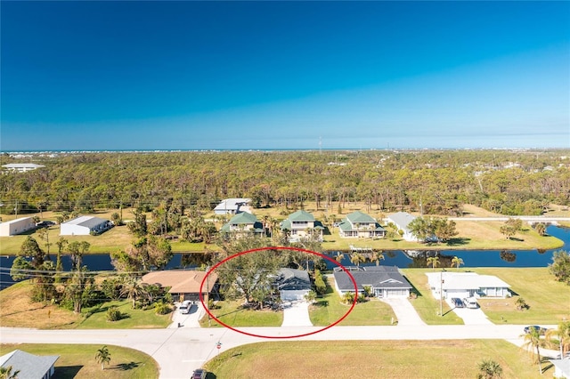 217 Rotonda Cir, Rotonda West, FL 33947 - aerial perspective of suburban area featuring a large body of water and a forest