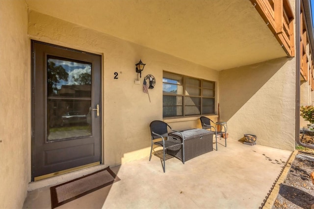 entrance to property featuring a patio