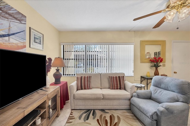 living room featuring ceiling fan and light tile patterned floors