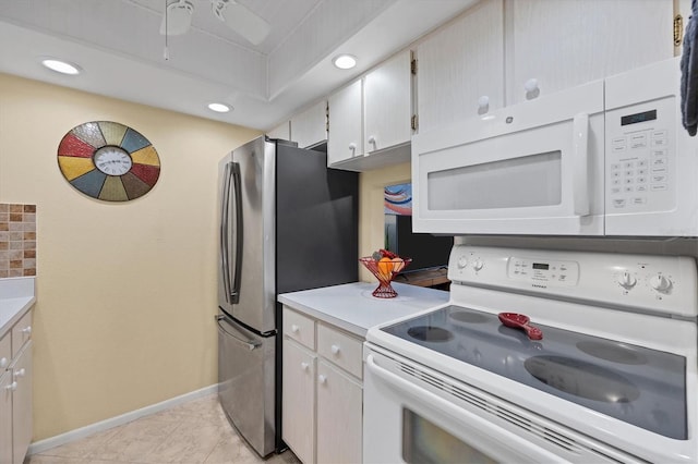 kitchen featuring white appliances, white cabinetry, and light tile patterned flooring