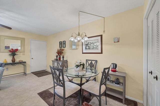 dining space featuring a notable chandelier and light tile patterned floors