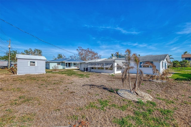 105 Crestview Dr, Englewood, FL 34223 - view of grassy yard with an outbuilding
