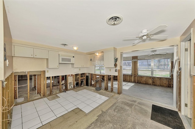 kitchen featuring cream cabinetry, ceiling fan, a healthy amount of sunlight, and light tile patterned floors