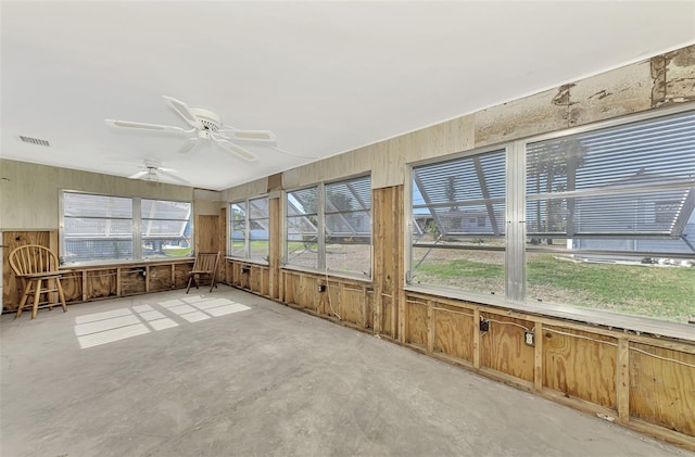 unfurnished sunroom with ceiling fan and a wealth of natural light