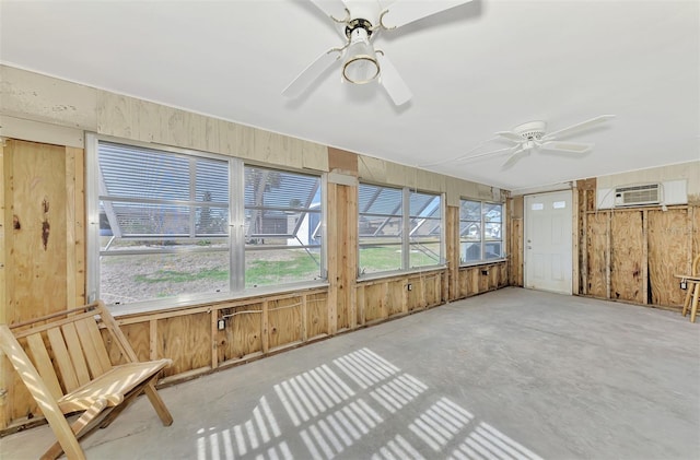 105 Crestview Dr, Englewood, FL 34223 - unfurnished sunroom featuring a ceiling fan, unfinished concrete flooring, an AC wall unit, and wooden walls