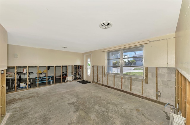 unfurnished room with concrete floors