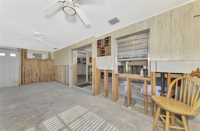 105 Crestview Dr, Englewood, FL 34223 - living area featuring a ceiling fan, wood walls, and a wall mounted AC