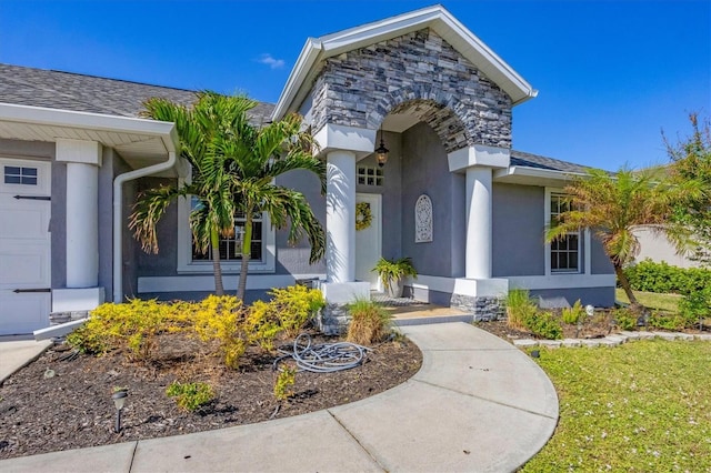 entrance to property featuring a lawn