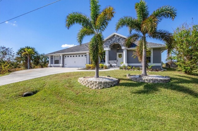 10083 Kansas City St, Port Charlotte, FL 33981 - view of front of home featuring an attached garage, driveway, a front yard, and stucco siding