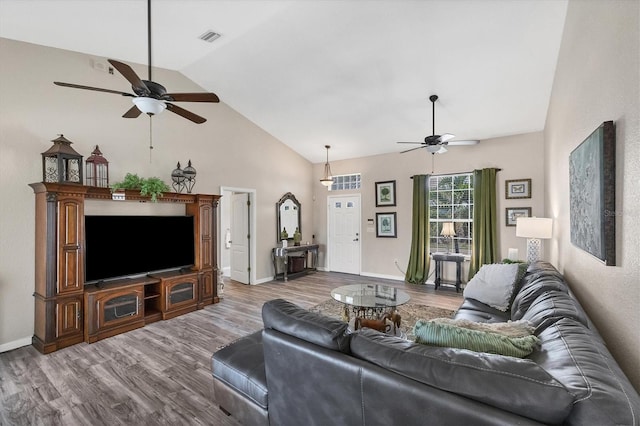 living room featuring high vaulted ceiling, hardwood / wood-style flooring, and ceiling fan