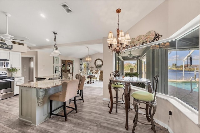 kitchen with light hardwood / wood-style flooring, white cabinetry, sink, and stainless steel appliances