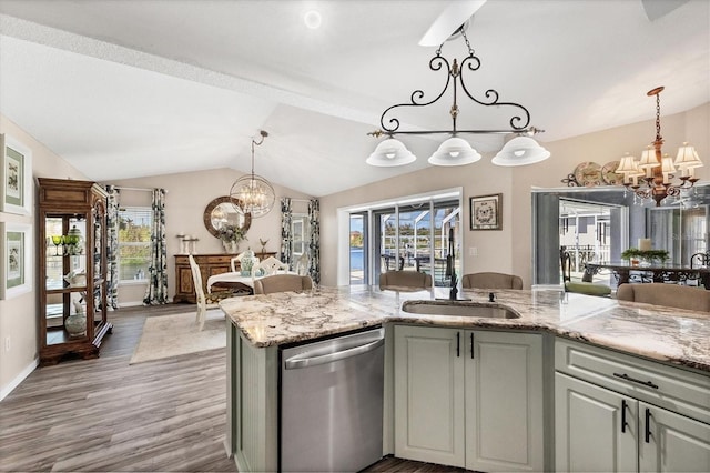 kitchen featuring dishwasher, lofted ceiling, hardwood / wood-style flooring, and an inviting chandelier