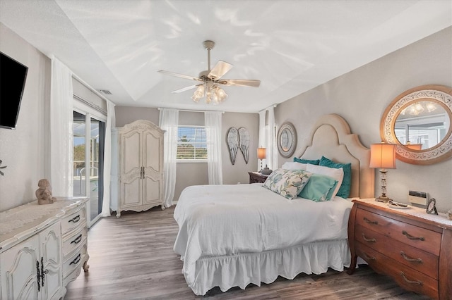 bedroom with access to exterior, dark wood-type flooring, and ceiling fan