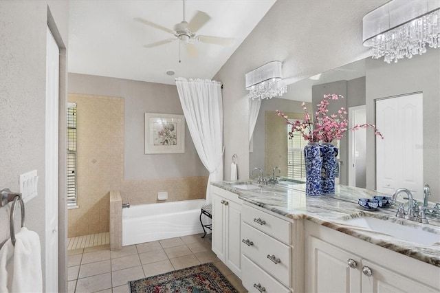 bathroom featuring tile patterned flooring, a bathtub, vanity, and ceiling fan with notable chandelier