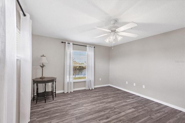10083 Kansas City St, Port Charlotte, FL 33981 - spare room featuring dark wood-type flooring, a ceiling fan, and baseboards