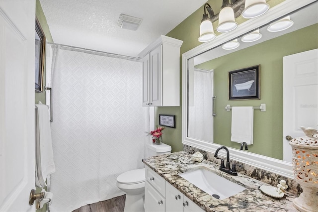 10083 Kansas City St, Port Charlotte, FL 33981 - bathroom featuring toilet, a shower with shower curtain, vanity, wood finished floors, and a textured ceiling