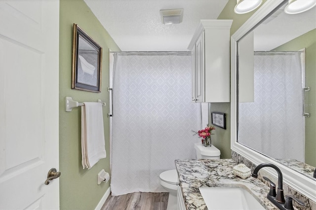 10083 Kansas City St, Port Charlotte, FL 33981 - bathroom with wood finished floors, toilet, vanity, a shower with curtain, and a textured ceiling