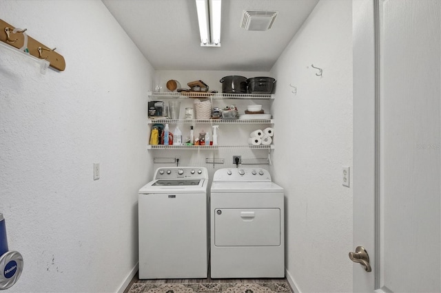 clothes washing area featuring washer and clothes dryer