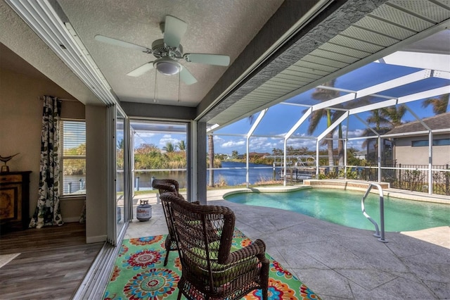 10083 Kansas City St, Port Charlotte, FL 33981 - view of swimming pool featuring a water view, a ceiling fan, a patio, and glass enclosure