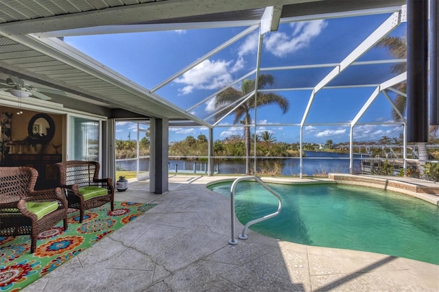 view of swimming pool featuring ceiling fan, a lanai, a water view, and a patio area