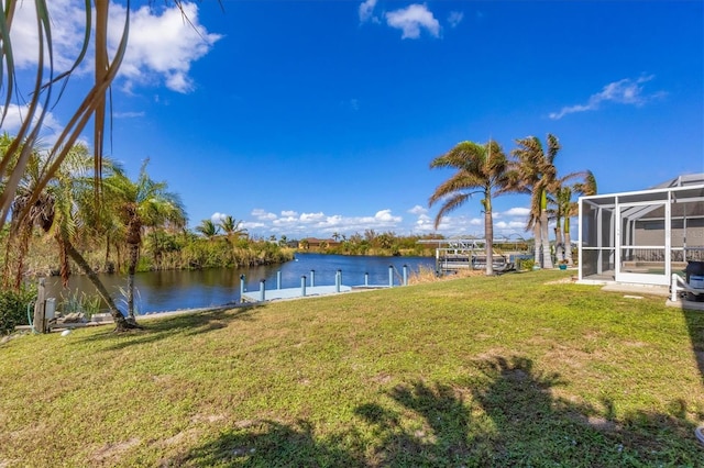 10083 Kansas City St, Port Charlotte, FL 33981 - view of green lawn featuring a water view, a dock, and glass enclosure