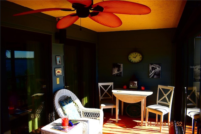 interior space with ceiling fan