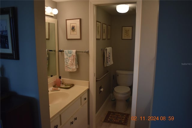 bathroom featuring vanity and toilet