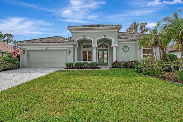 mediterranean / spanish-style home featuring a garage and a front yard