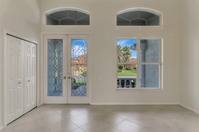 foyer with french doors and light tile patterned floors