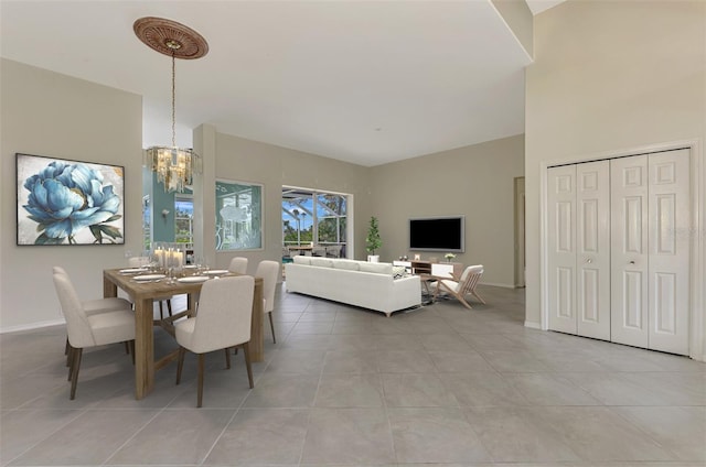 dining area featuring light tile patterned floors and a notable chandelier