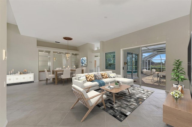 living room featuring light tile patterned floors and an inviting chandelier