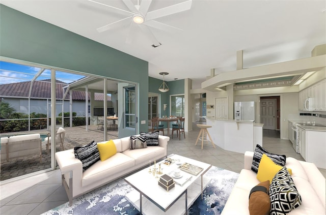 living room featuring light tile patterned floors and ceiling fan