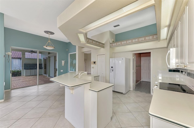 kitchen featuring white cabinetry, light tile patterned floors, decorative light fixtures, white appliances, and a kitchen island with sink