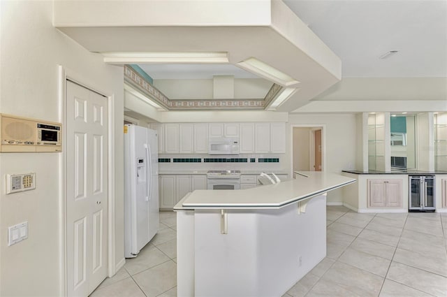 kitchen featuring a breakfast bar area, backsplash, a spacious island, white appliances, and wine cooler