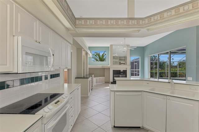 kitchen featuring white cabinets, white appliances, and sink