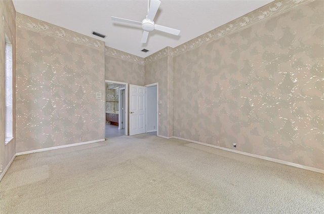 unfurnished room with ceiling fan and carpet flooring