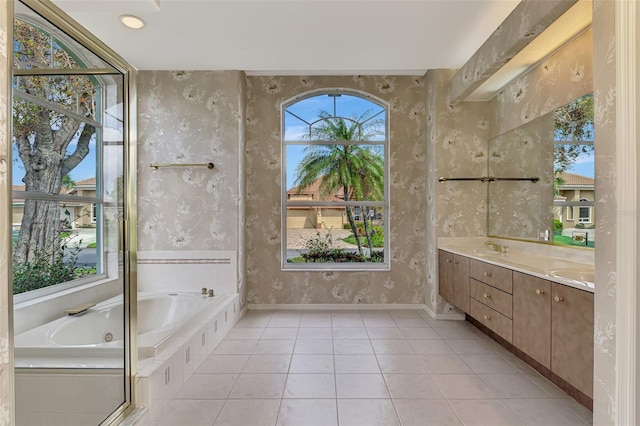 bathroom with vanity, tile patterned flooring, and tiled tub