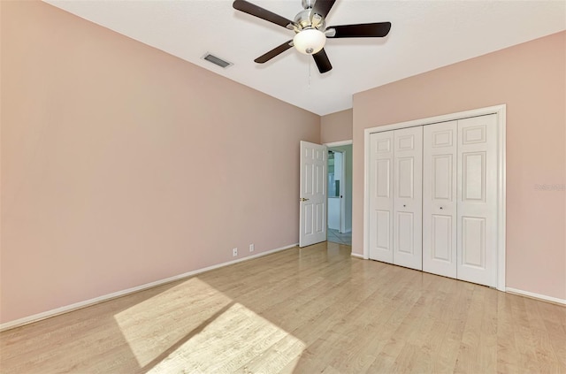 unfurnished bedroom with a closet, light hardwood / wood-style floors, and ceiling fan