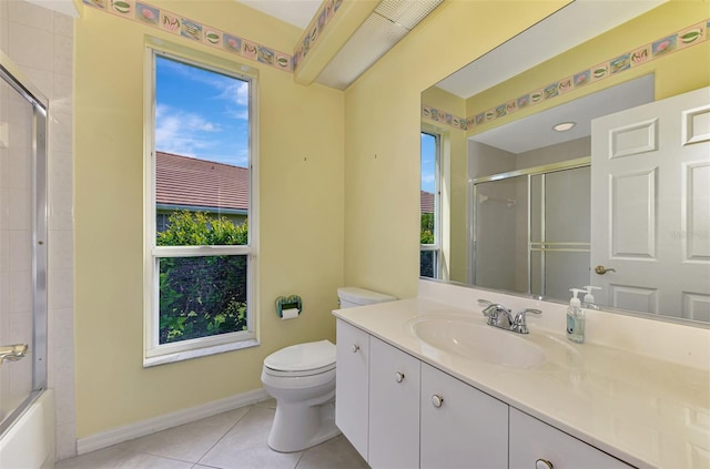 full bathroom featuring toilet, vanity, tile patterned flooring, and enclosed tub / shower combo