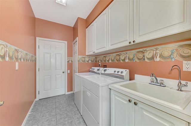 laundry area with cabinets, sink, independent washer and dryer, and light tile patterned floors