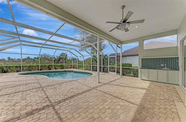 view of swimming pool featuring a lanai, ceiling fan, and a patio