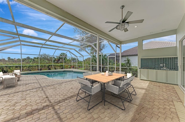 view of pool featuring a lanai, ceiling fan, and a patio area